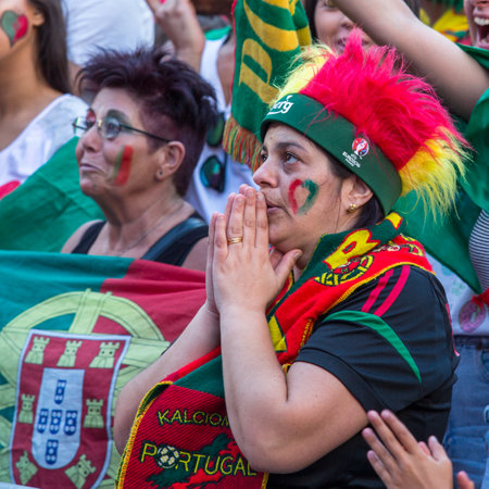 PORTO, PORTUGAL - JUL 10, 2016: Portuguese fans during translation of the football match Portugal - France final of the European championship 2016, in Liberdade Square at city center of Porto.のeditorial素材