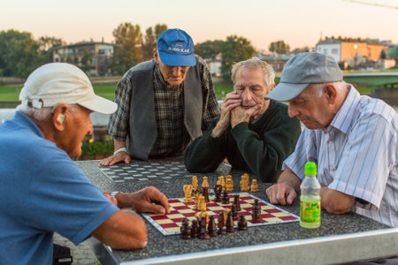 KRAKOW, POLAND - FEB 8, 2016: Unidentified elderly mens play chess on the embankment of Vistula. The largest population of Krakow was recorded by Jun  2015 â according to GUS 762 508 residents.のeditorial素材