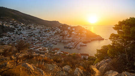 Beautiful sunset of Hydra island, Greece - top view of city center and yaht marina.の写真素材