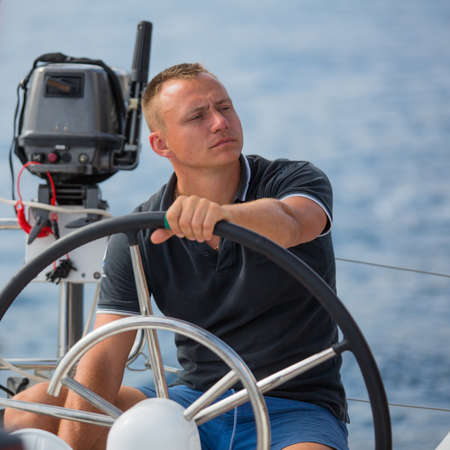 Skipper drive a sailing boat.