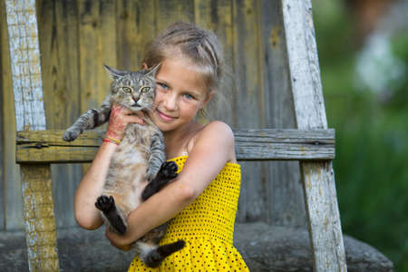 Little girl posing with a cat.の写真素材