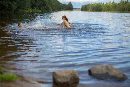 Two naughty girls bathe in the lake.の写真素材