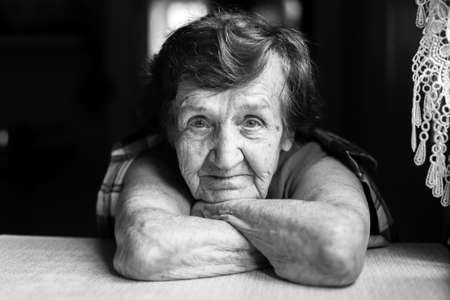 Closeup portrait of an elderly woman in contrast of black and white.