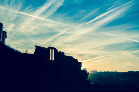 Silhouette of abandoned building against the blue sky at dusk.の写真素材