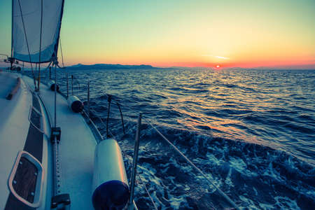 Amazing sunset at sea on a sailing yacht.の写真素材