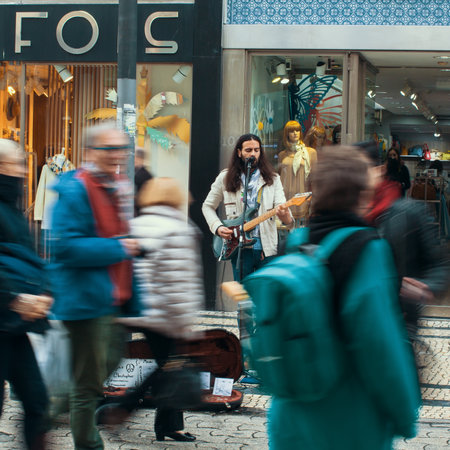 PORTO, PORTUGAL - MAR 4, 2017: Unknown street musician on one of the streets in old downtown. City of Porto was elected from 20 selected Best European Destination 2017 and won this prestigious title.のeditorial素材