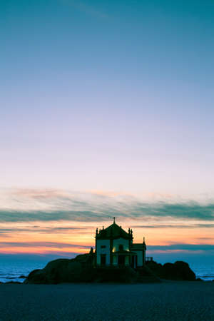 Chapel Senhor da Pedra at night time, Miramar Beach, Portugal.の写真素材