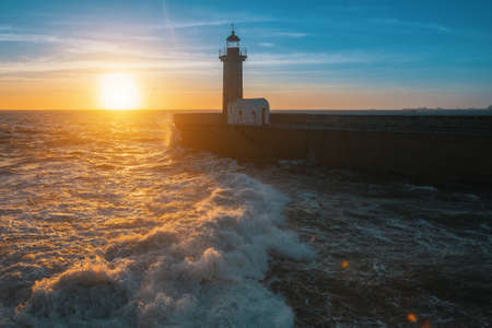 Beautiful ocean sunset and surf at the lighthouse.の写真素材