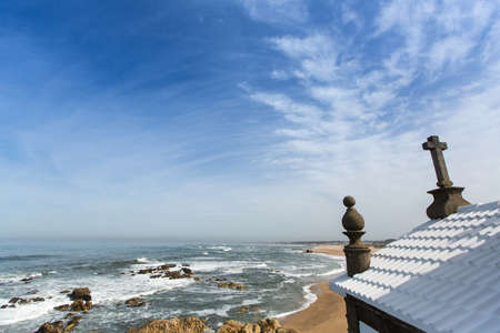 Chapel Senhor da Pedra at Miramar Beach, Atlantic ocean near Porto, Portugal.の写真素材