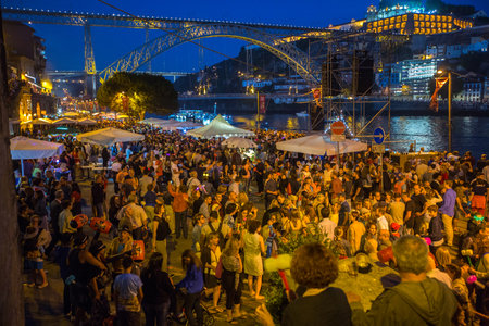 PORTO, PORTUGAL - JUN 24, 2017: Participants Sao Joao Festival (birth of St.John the Baptist) Very popular holiday is celebrated 23-24 June at midnight, next to the Douro River and Dom Luis I bridge.のeditorial素材