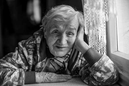 Black and white portrait Russian grandmother. An elderly woman in her home.の写真素材