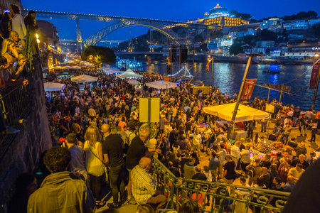 PORTO, PORTUGAL - JUN 24, 2017: Participants Sao Joao Festival (birth of St.John the Baptist) Very popular holiday is celebrated 23-24 June at midnight, next to the Douro River and Dom Luis I bridge.のeditorial素材