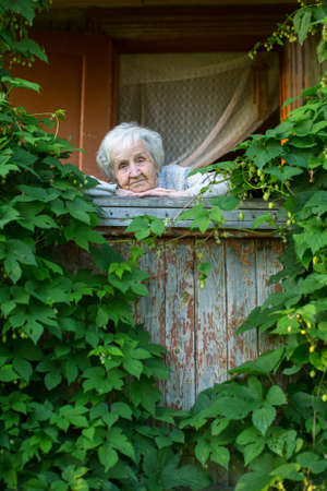 An elderly woman in his village house.の写真素材