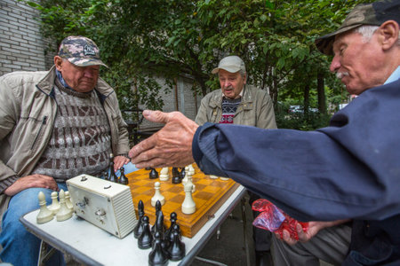 St. PETERSBURG, RUSSIA - SEP 2, 2017: Pensioners play chess in the courtyard of an apartment building. In Petersburg among the population the share of pensioners is approximately 24.4 percent.のeditorial素材