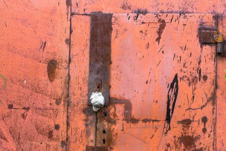 Rusty metal wall and door with peeling paint.の写真素材