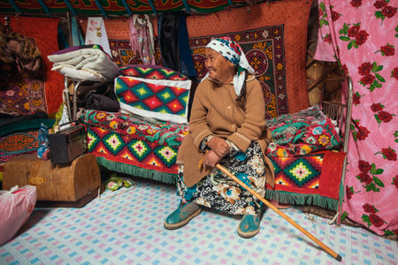 BAYAN-OLGII, MONGOLIA - SEP 28, 2017: Old woman from Kazakh family of hunters with hunting golden eagles inside their the mongolian Yurts. In Bayan-Olgii Province is populated to 88,7% by Kazakhs.のeditorial素材
