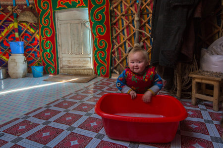 BAYAN-OLGII, MONGOLIA - SEP 28, 2017: Kazakh family of hunters with hunting birds (golden eagles) inside the mongolian Yurt. In Bayan-Olgii Province is populated mainly by Kazakhs (88,7 %)のeditorial素材