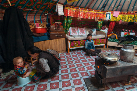 BAYAN-OLGII, MONGOLIA - SEP 28, 2017: Kazakhs family of hunters with hunting golden eagles inside their the mongolian Yurts. In Bayan-Olgii Province is populated to 88,7% by Kazakhs.のeditorial素材