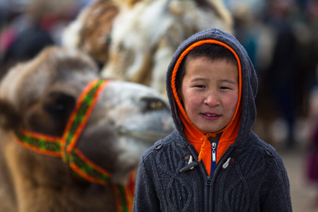 OLGIY, MONGOLIA - SEP 30, 2017: Unidentified Mongolian child during annual national competition with birds of prey "Berkutchi" of West Mongolia.のeditorial素材