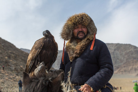OLGIY, MONGOLIA - SEP 30, 2017: Kazakh Golden Eagle Hunter at traditional clothing, during annual national competition with birds of prey "Berkutchi" of West Mongolia.のeditorial素材