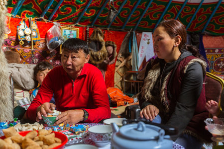 BAYAN-OLGII, MONGOLIA - SEP 28, 2017: Kazakhs family of hunters with hunting golden eagles inside their the mongolian Yurts. In Bayan-Olgii Province is populated to 88,7% by Kazakhs.のeditorial素材