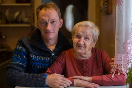 Portrait of an elderly woman with a grown son.