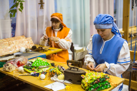VAZHINY, LENINGRAD REGION, RUSSIA - DEC 21, 2017: Weaver while working in the Textile Studio of decorative art "Tekstilnaya Plastika", at municipal budgetary institution of culture.のeditorial素材