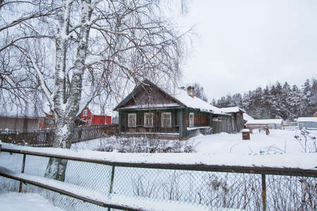 Village houses in winter in the Leningrad region of Russia.の写真素材
