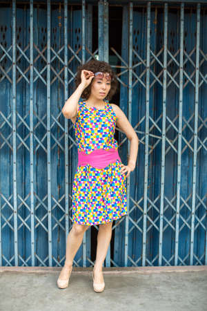 Young asian woman standing outdoors. Full-body portrait.の写真素材