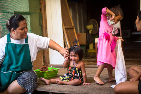 KO CHANG, THAILAND - FEB 15, 2018: Local inhabitants of the Bang Bao fishing village, which consists of houses on stilts built into the sea. Ko Chang consisting of 8 villages with 5,356 inhabitants.のeditorial素材