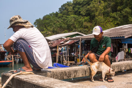 KOH CHANG, THAILAND - FEB 17, 2018: Locals of Fishing village on the Eastern shore, which consists of houses on stilts built into the sea. Island consisting of 8 villages with 5,356 inhabitants.のeditorial素材