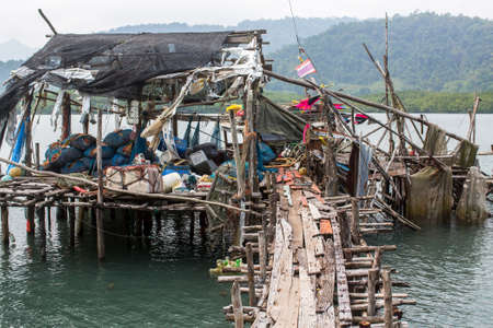 Fishing tackle on Pier made of wooden planks in the fishing village on Ko Chang island, Thailand.の写真素材