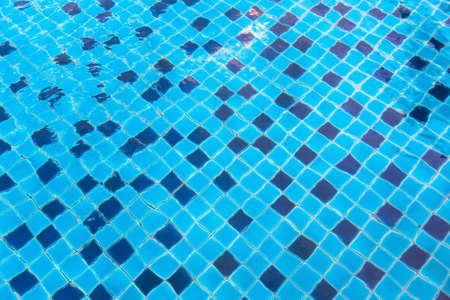 Ceramic baseboard at the bottom of the pool view through the water.の写真素材