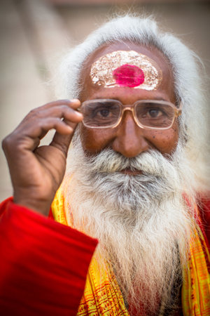 VARANASI, INDIA - MAR 15, 2018: Sadhu (holy man) on Dashashwamedh Ghat is the main and probably oldest ghat of Varanasi located on the Ganges, close to Kashi Vishwanath Temple.のeditorial素材