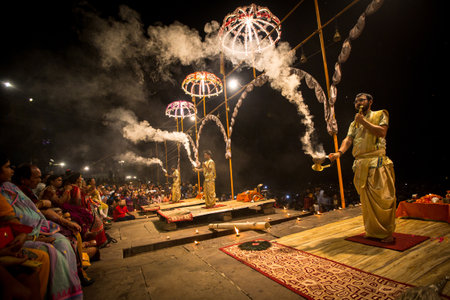 VARANASI, INDIA - MAR 15, 2018: A group of priests perform Agni Pooja (Sanskrit: Worship of Fire) on Dashashwamedh Ghat - main and oldest ghat of Varanasi located on the Ganges.のeditorial素材