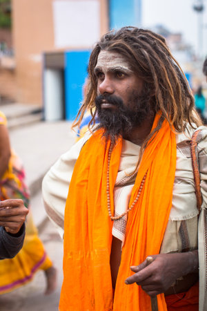 VARANASI, INDIA - MAR 15, 2018: Sadhu (holy man) on Dashashwamedh Ghat is the main and probably oldest ghat of Varanasi located on the Ganges, close to Kashi Vishwanath Temple.のeditorial素材
