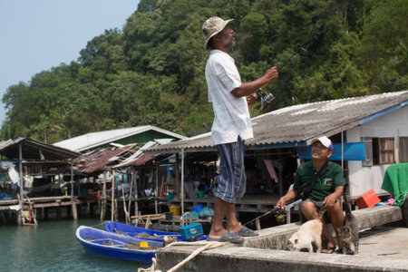 KOH CHANG, THAILAND - FEB 17, 2018: Locals of Fishing village on the Eastern shore, which consists of houses on stilts built into the sea. Island consisting of 8 villages with 5,356 inhabitants.のeditorial素材