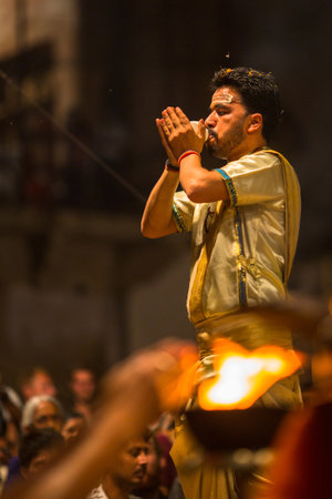 VARANASI, INDIA - MAR 18, 2018: Hindu priest perform Agni Pooja (Sanskrit: Worship of Fire) on Dashashwamedh Ghat - main and oldest ghat of Varanasi located on the Ganges.のeditorial素材