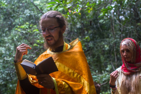 KOH CHANG, THAILAND - MAR 9, 2018: Orthodox priest during sacrament of spiritual birth - Baptism....