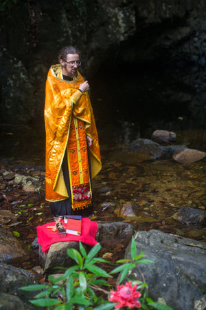 KOH CHANG, THAILAND - MAR 9, 2018: Orthodox priest during sacrament of spiritual birth - Baptism. There are currently 10 Orthodox parishes in Thailand, Orthodoxy is practiced by 0.002% of population.のeditorial素材