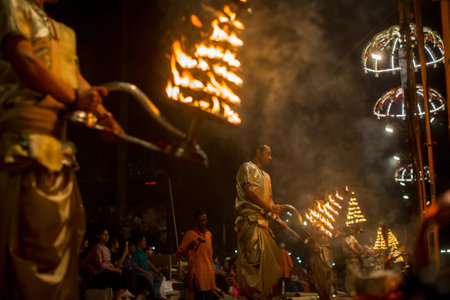 VARANASI, INDIA - MAR 23, 2018: Hindu priests perform Agni Pooja (Sanskrit: Worship of Fire) on...