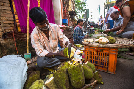 VARANASI, INDIA - MAR 26, 2018: Street seller of greenery and vegetables. According to legends, the...