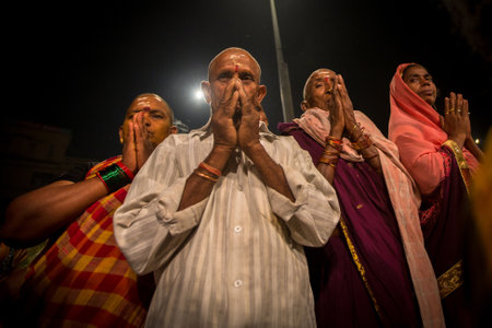VARANASI, INDIA - MAR 15, 2018: Pilgrims during perform Agni Pooja (Sanskrit: Worship of Fire) on Dashashwamedh Ghat - main and oldest ghat of Varanasi located on the Ganges.のeditorial素材