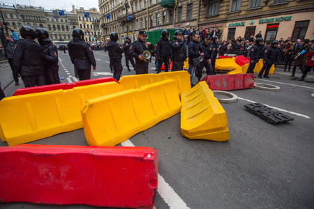 ST. PETERSBURG, RUSSIA - MAY 5, 2018: Police officers in riot gear block an Nevsky prospect during...
