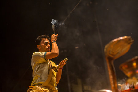 VARANASI, INDIA - MAR 23, 2018: Hindu priests perform Agni Pooja (Sanskrit: Worship of Fire) on Dashashwamedh Ghat - main and oldest ghat of Varanasi located on the Ganges.のeditorial素材