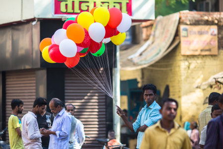 VARANASI, INDIA - MAR 25, 2018: Indian seller of balloons near the holy Ganges river. According to legends, Varanasi city was founded by God Shiva about 5000 years ago.のeditorial素材