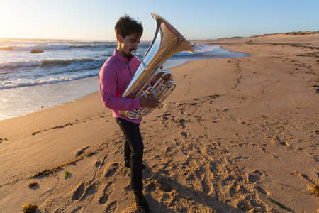 Musician play Tuba on the ocean coast. の写真素材