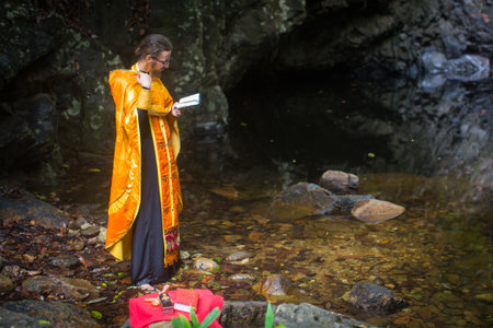 KOH CHANG, THAILAND - MAR 9, 2018: Orthodox priest during sacrament of spiritual birth - Baptism. There are currently 10 Orthodox parishes in Thailand, Orthodoxy is practiced by 0.002% of population.のeditorial素材