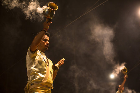VARANASI, INDIA - MAR 23, 2018: Hindu priests perform Agni Pooja (Sanskrit: Worship of Fire) on Dashashwamedh Ghat - main and oldest ghat of Varanasi located on the Ganges.のeditorial素材