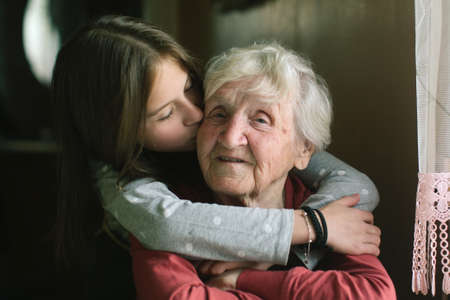 Little girl kissing her grandmother.の写真素材